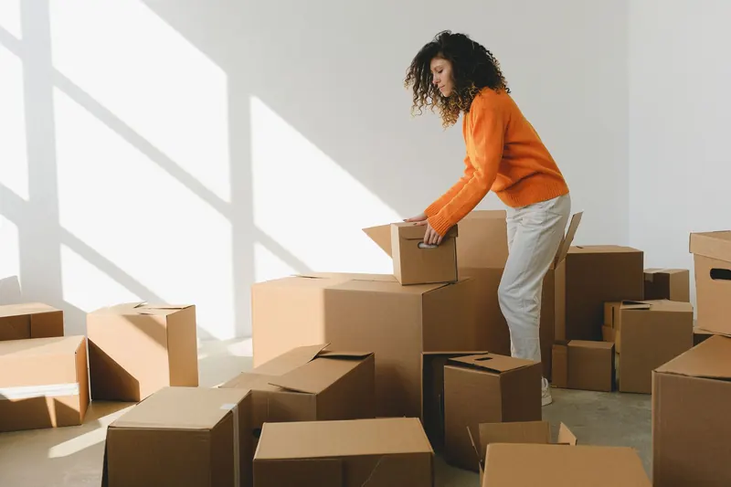 Moving boxes in a bright, empty room